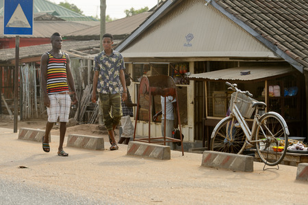 ACCRA, GHANA - Jan 8, 2017: Unidentified Ghanaian boys walk on the street. People of Ghana suffer of...