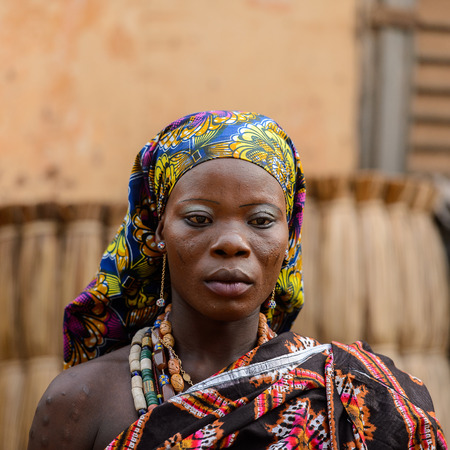 OUIDAH, BENIN - Jan 10, 2017: Unidentified Beninese woman in national suit wears necklace and earings at the voodoo festival, which is anually celebrated on January, 10th.のeditorial素材