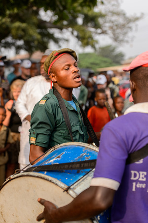 OUIDAH, BENIN - Jan 10, 2017: Unidentified Beninese man in shirt and a cap seriously looks ahead at the voodoo festival, which is anually celebrated on January, 10th.のeditorial素材