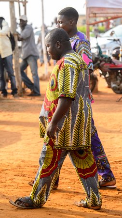OUIDAH, BENIN - Jan 10, 2017: Unidentified Beninese man in national suit walks at the voodoo festival, which is anually celebrated on January, 10th.のeditorial素材