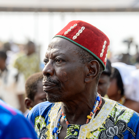 OUIDAH, BENIN - Jan 10, 2017: Unidentified Beninese man in national suit attentively looks ahead at the voodoo festival, which is anually celebrated on January, 10th.のeditorial素材