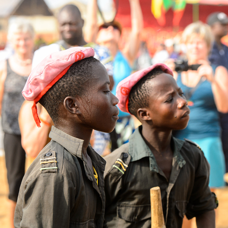 OUIDAH, BENIN - Jan 10, 2017: Unidentified Beninese boy in shirt and a cap seriously looks ahead at the voodoo festival, which is anually celebrated on January, 10th.のeditorial素材