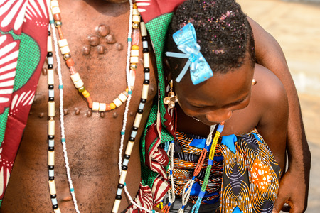 OUIDAH, BENIN - Jan 10, 2017: Unidentified Beninese  little girl in national suit looks down at the voodoo festival, which is anually celebrated on January, 10th.のeditorial素材