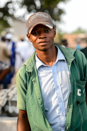 OUIDAH, BENIN - Jan 10, 2017: Unidentified Beninese man in a shirt and a cap looks ahead at the voodoo festival, which is anually celebrated on January, 10th.のeditorial素材