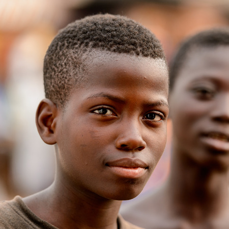 LOME, TOGO - Jan 9, 2017: Unidentified Togolese young boy looks ahead. Togo children suffer of poverty due to the bad economyのeditorial素材