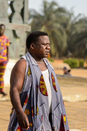 OUIDAH, BENIN - Jan 10, 2017: Unidentified Beninese  man in national suit looks ahead at the voodoo festival, which is anually celebrated on January, 10th.のeditorial素材