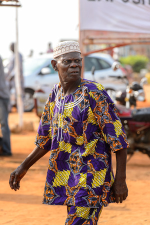 OUIDAH, BENIN - Jan 10, 2017: Unidentified Beninese man in national suit looks around at the voodoo festival, which is anually celebrated on January, 10th.のeditorial素材