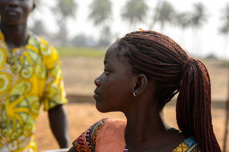 OUIDAH, BENIN - Jan 10, 2017: Unidentified Beninese beautiful young girl with braids at the voodoo festival, which is anually celebrated on January, 10th.のeditorial素材