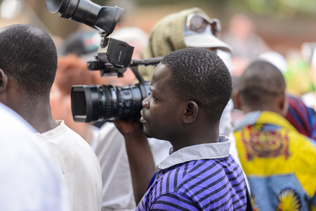 OUIDAH, BENIN - Jan 10, 2017: Unidentified Beninese  man shoots on videocamera at the voodoo festival, which is anually celebrated on January, 10th.のeditorial素材