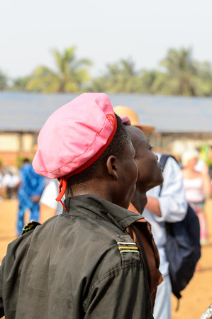 OUIDAH, BENIN - Jan 10, 2017: Unidentified Beninese boy in shirt and a cap seriously looks ahead at the voodoo festival, which is anually celebrated on January, 10th.のeditorial素材