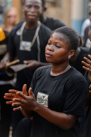 OUIDAH, BENIN - Jan 10, 2017: Unidentified Beninese beautiful woman in black shirt claps her hands at the voodoo festival, which is anually celebrated on January, 10th.のeditorial素材