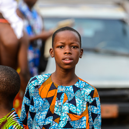 OUIDAH, BENIN - Jan 10, 2017: Unidentified Beninese  little boy in colored suit stands at the voodoo festival, which is anually celebrated on January, 10th.のeditorial素材