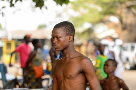 OUIDAH, BENIN - Jan 10, 2017: Unidentified Beninese topless boy looks ahead at the voodoo festival, which is anually celebrated on January, 10th.のeditorial素材