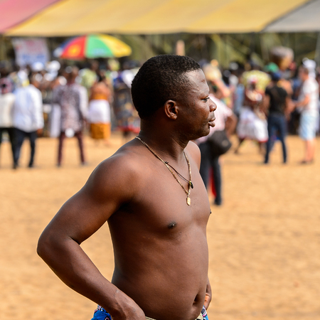 OUIDAH, BENIN - Jan 10, 2017: Unidentified Beninese topless man wears necklace at the voodoo festival, which is anually celebrated on January, 10th.のeditorial素材
