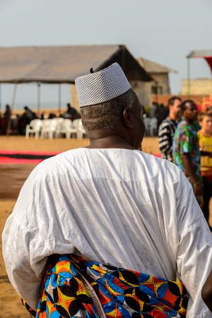 OUIDAH, BENIN - Jan 10, 2017: Unidentified Beninese man in national suit from behind at the voodoo festival, which is anually celebrated on January, 10th.のeditorial素材