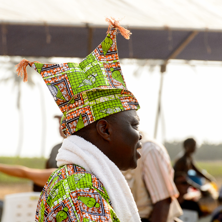 OUIDAH, BENIN - Jan 10, 2017: Unidentified Beninese man in national suit looks ahead at the voodoo festival, which is anually celebrated on January, 10th.のeditorial素材