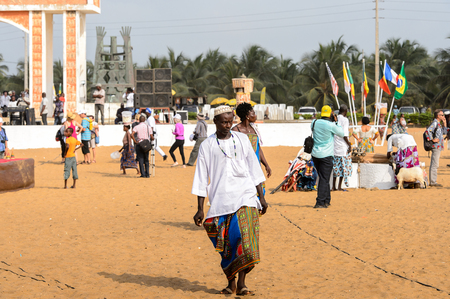 OUIDAH, BENIN - Jan 10, 2017: Unidentified Beninese man in colored national clothes walks at the voodoo festival, which is anually celebrated on January, 10th.のeditorial素材