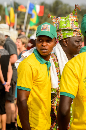 OUIDAH, BENIN - Jan 10, 2017: Unidentified Beninese man in shirt and a cap seriously looks ahead at the voodoo festival, which is anually celebrated on January, 10th.のeditorial素材
