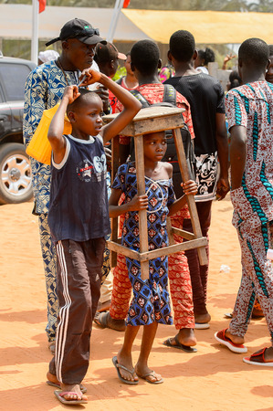 OUIDAH, BENIN - Jan 10, 2017: Unidentified Beninese group of people in colored clothes walk at the voodoo festival, which is anually celebrated on January, 10th.のeditorial素材