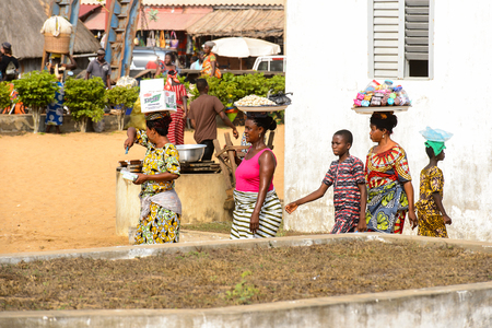 OUIDAH, BENIN - Jan 10, 2017: Unidentified Beninese people carry trays on their heads at the voodoo festival, which is anually celebrated on January, 10th.のeditorial素材