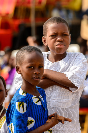 OUIDAH, BENIN - Jan 10, 2017: Unidentified Beninese little boys look ahead at the voodoo festival, which is anually celebrated on January, 10th.のeditorial素材