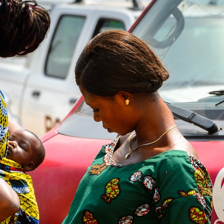 OUIDAH, BENIN - Jan 10, 2017: Unidentified Beninese woman in colored dress looks down at the voodoo festival, which is anually celebrated on January, 10th.のeditorial素材