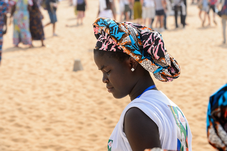 OUIDAH, BENIN - Jan 10, 2017: Unidentified Beninese woman in national suit wears earings at the voodoo festival, which is anually celebrated on January, 10th.のeditorial素材