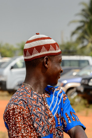 OUIDAH, BENIN - Jan 10, 2017: Unidentified Beninese man in colored clothes wears necklace at the voodoo festival, which is anually celebrated on January, 10th.のeditorial素材