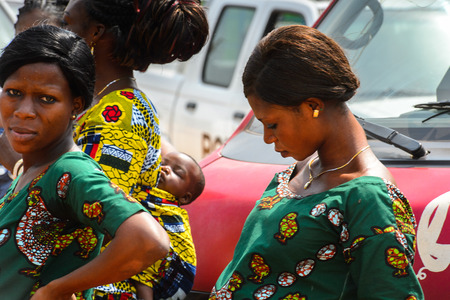 OUIDAH, BENIN - Jan 10, 2017: Unidentified Beninese woman in colored dress looks down at the voodoo festival, which is anually celebrated on January, 10th.のeditorial素材