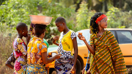 OUIDAH, BENIN - Jan 10, 2017: Unidentified Beninese women in colored clothes stand in circle at the voodoo festival, which is anually celebrated on January, 10th.のeditorial素材