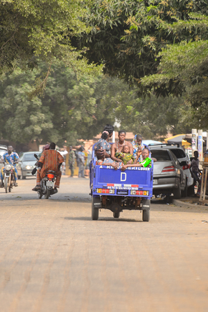 OUIDAH, BENIN - Jan 10, 2017: Unidentified Beninese women ride in the car without a roof. Benin people suffer of poverty due to the bad economyのeditorial素材