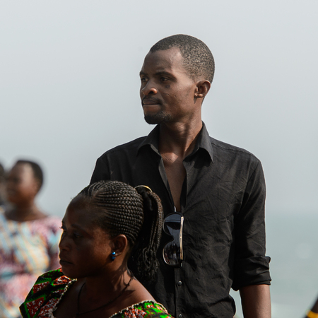 OUIDAH, BENIN - Jan 10, 2017: Unidentified Beninese man in black shirt looks away at the voodoo festival, which is anually celebrated on January, 10th.のeditorial素材