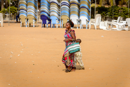 OUIDAH, BENIN - Jan 10, 2017: Unidentified Beninese woman in national suit walks at the voodoo festival, which is anually celebrated on January, 10th.のeditorial素材