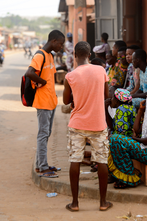 OUIDAH, BENIN - Jan 10, 2017: Unidentified Beninese people talk about something on the street. Benin people suffer of poverty due to the bad economyのeditorial素材