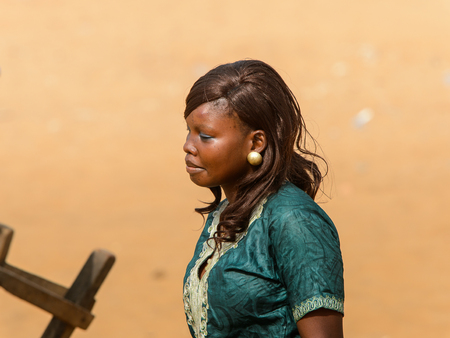 OUIDAH, BENIN - Jan 10, 2017: Unidentified Beninese beautiful woman walks at the voodoo festival, which is anually celebrated on January, 10th.のeditorial素材