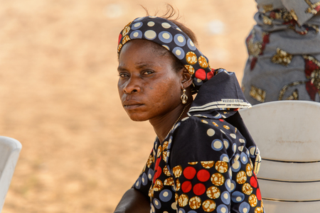 OUIDAH, BENIN - Jan 10, 2017: Unidentified Beninese woman in national suit wears necklace and earings at the voodoo festival, which is anually celebrated on January, 10th.のeditorial素材