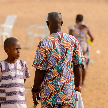 OUIDAH, BENIN - Jan 10, 2017: Unidentified Beninese man in colored shirt from behind at the voodoo festival, which is anually celebrated on January, 10th.のeditorial素材