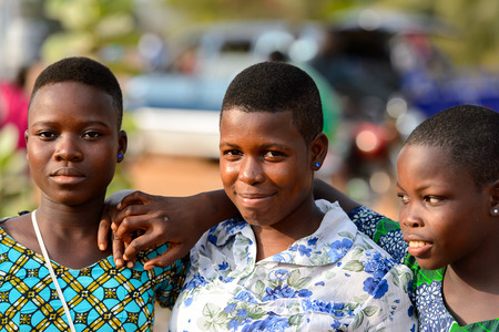 OUIDAH, BENIN - Jan 10, 2017: Unidentified Beninese beautiful girls at the local market. Benin people suffer of poverty due to the bad economyのeditorial素材