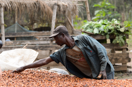 KUMASI, GHANA - Jan 16, 2017: Unidentified Ghanaian man in dirty clothes looks down. People of Ghana suffer of poverty due to the bad economyのeditorial素材