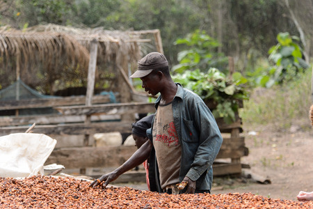 KUMASI, GHANA - Jan 16, 2017: Unidentified Ghanaian man in dirty clothes looks down. People of Ghana suffer of poverty due to the bad economyのeditorial素材