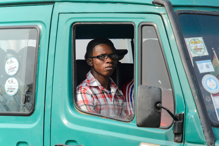 KUMASI, GHANA - Jan 16, 2017: Unidentified Ghanaian man looks out of car window. People of Ghana suffer of poverty due to the bad economyのeditorial素材