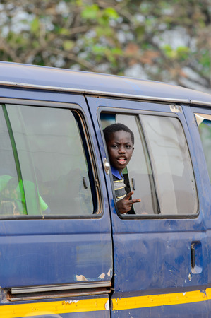 CENTRAL REGION, GHANA - Jan 17, 2017: Unidentified Ghanaian boy looks out of car window in local village. Children of Ghana suffer of poverty due to the bad economyのeditorial素材