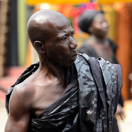 KUMASI, GHANA - Jan 16, 2017: Unidentified Ghanaian bald man in black clothes looks away. People of Ghana suffer of poverty due to the bad economyのeditorial素材