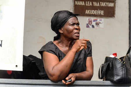 KUMASI, GHANA - Jan 16, 2017: Unidentified Ghanaian woman in black shirt and headscarf looks away. People of Ghana suffer of poverty due to the bad economyのeditorial素材