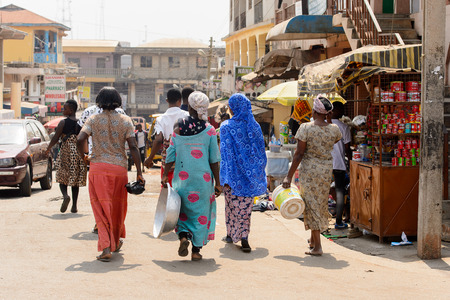 CENTRAL REGION, GHANA - Jan 17, 2017: Unidentified Ghanaian people walk on the street in local village. People of Ghana suffer of poverty due to the bad economyのeditorial素材