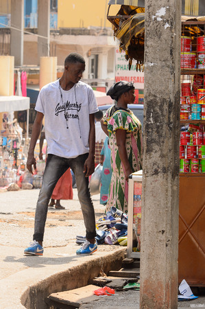CENTRAL REGION, GHANA - Jan 17, 2017: Unidentified Ghanaian man in white shirt looks away in local village. People of Ghana suffer of poverty due to the bad economyのeditorial素材