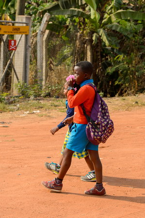 CENTRAL REGION, GHANA - Jan 17, 2017: Unidentified Ghanaian pupils walk along the street in local village. Children of Ghana suffer of poverty due to the bad economyのeditorial素材