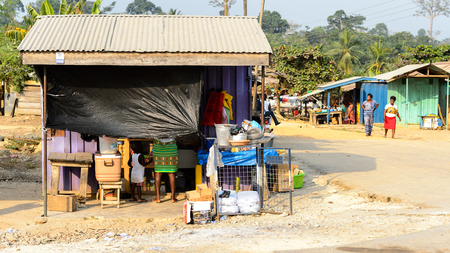 CENTRAL REGION, GHANA - Jan 17, 2017: Unidentified Ghanaian child stands near his mother in local village. People of Ghana suffer of poverty due to the bad economyのeditorial素材