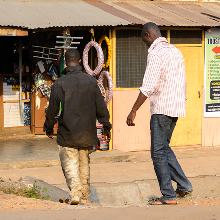 CENTRAL REGION, GHANA - Jan 17, 2017: Unidentified Ghanaian men from behind in local village. People of Ghana suffer of poverty due to the bad economyのeditorial素材