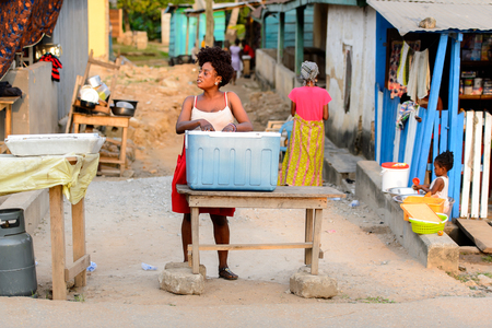 CENTRAL REGION, GHANA - Jan 17, 2017: Unidentified Ghanaian woman puts her hands into the bucket in local village. People of Ghana suffer of poverty due to the bad economyのeditorial素材